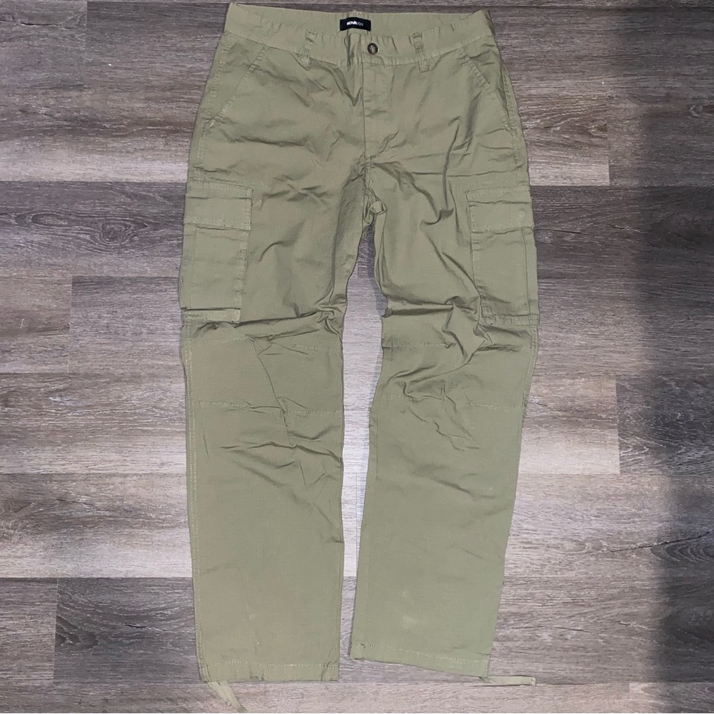 Khaki green cargo pants with drawstrings at the bottom